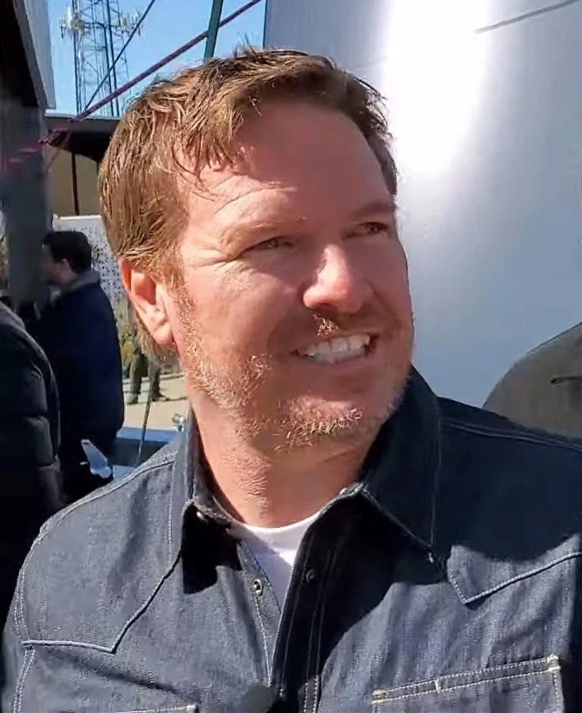 Chip Gaines smiling outdoors during filming at Magnolia.